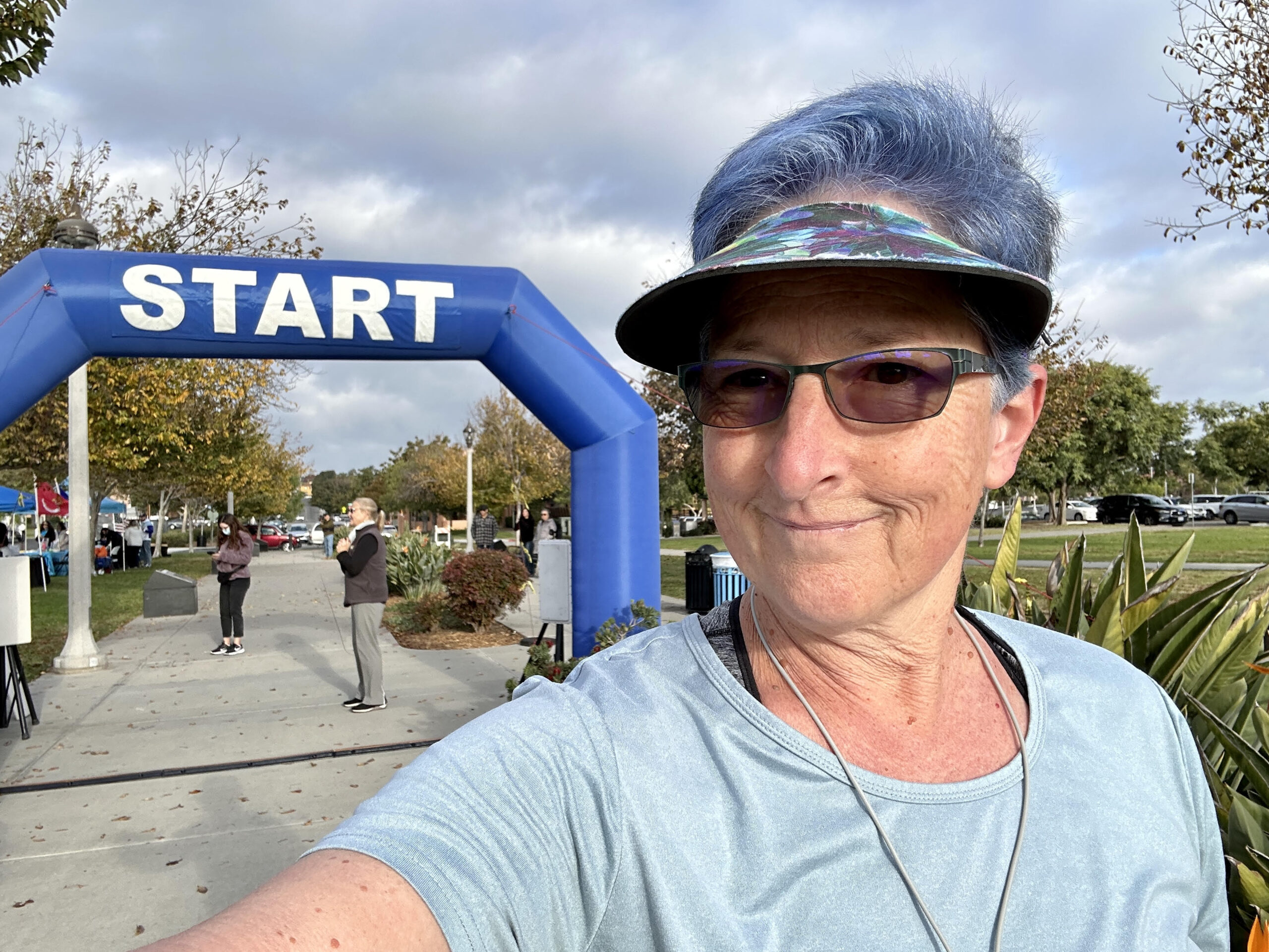 Linda Eskin standing near the starting line at her first 5K, at age 60.